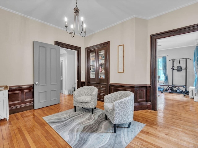 65 Congress St, Saint Albans City, VT 05478 - sitting room with light wood-type flooring, a chandelier, ornamental molding, and wainscoting