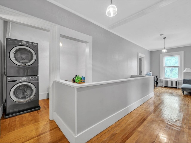 65 Congress St, Saint Albans City, VT 05478 - hallway featuring radiator, stacked washer / drying machine, hardwood / wood-style flooring, ornamental molding, and baseboards