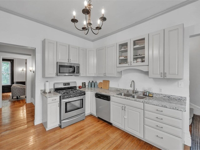 65 Congress St, Saint Albans City, VT 05478 - kitchen featuring appliances with stainless steel finishes, a sink, a chandelier, glass insert cabinets, and light wood-style flooring