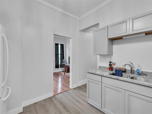 65 Congress St, Saint Albans City, VT 05478 - kitchen featuring freestanding refrigerator, a sink, ornamental molding, light wood-style flooring, and baseboards