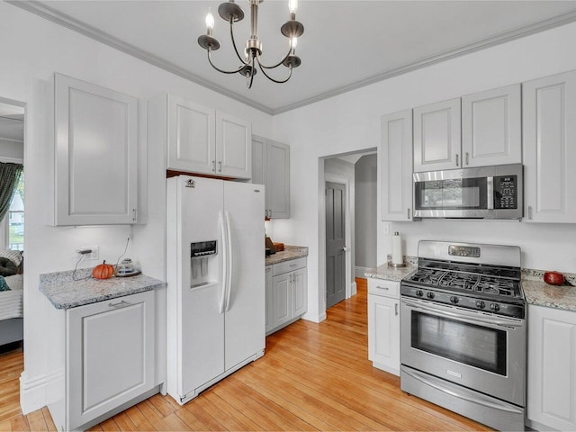 65 Congress St, Saint Albans City, VT 05478 - kitchen featuring appliances with stainless steel finishes, a chandelier, light wood-style flooring, ornamental molding, and light stone counters