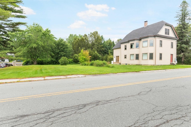 1165 Vt Route 253, Canaan, VT 05903 - view of home's exterior featuring a chimney, a yard, and roof with shingles