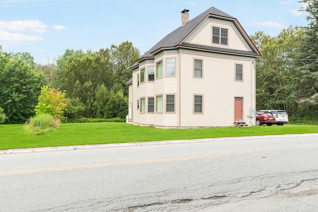 1165 Vt Route 253, Canaan, VT 05903 - view of property exterior with a chimney and a lawn
