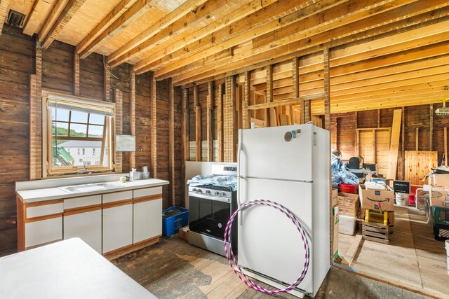 1165 Vt Route 253, Canaan, VT 05903 - kitchen featuring gas stove, freestanding refrigerator, white cabinets, and light countertops