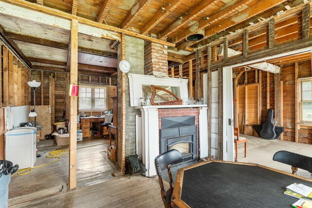 1165 Vt Route 253, Canaan, VT 05903 - unfurnished living room featuring wood walls, wooden ceiling, hardwood / wood-style flooring, and a wood stove
