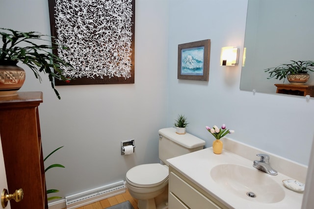 205 Mountain Rd, Concord, NH 03301 - half bath featuring a baseboard heating unit, toilet, and vanity