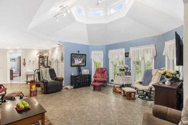 128 Fuller Dr, Canaan, VT 05903 - living area with healthy amount of natural light, track lighting, and high vaulted ceiling