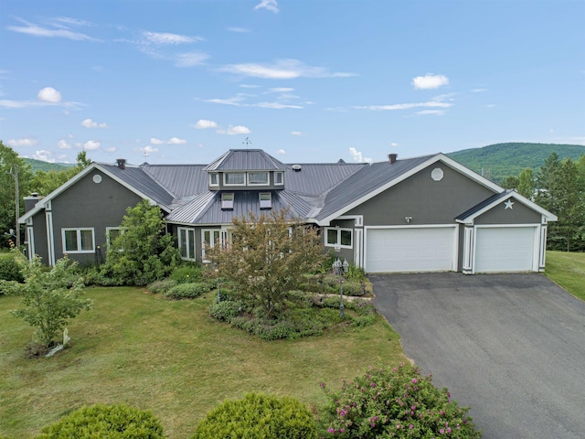 128 Fuller Dr, Canaan, VT 05903 - view of front of house featuring an attached garage, driveway, a front lawn, and metal roof