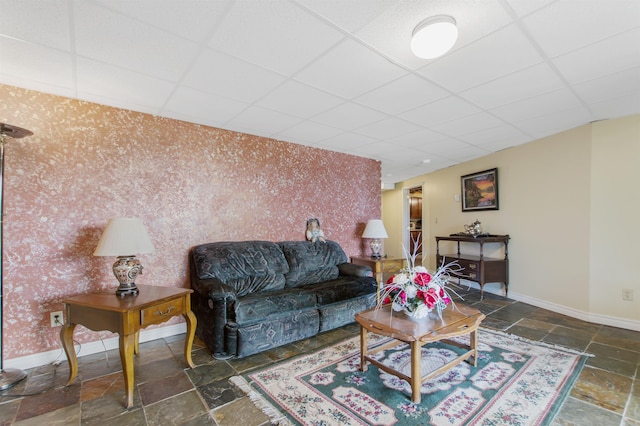 128 Fuller Dr, Canaan, VT 05903 - living area featuring a drop ceiling, stone tile flooring, baseboards, an accent wall, and wallpapered walls