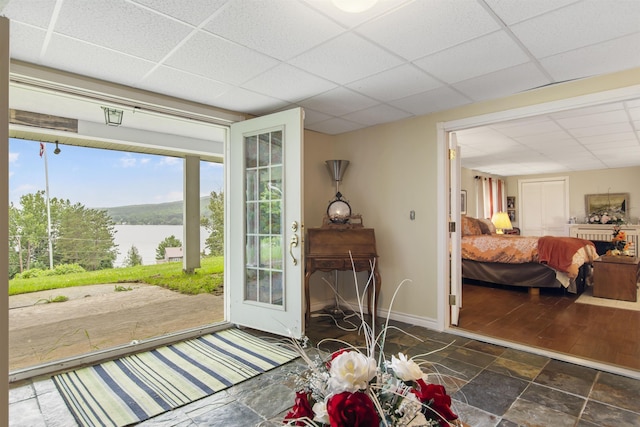 128 Fuller Dr, Canaan, VT 05903 - doorway featuring a paneled ceiling, a water view, stone finish flooring, and baseboards