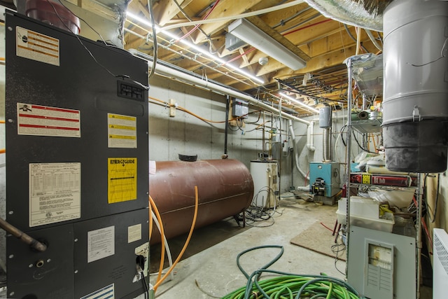 128 Fuller Dr, Canaan, VT 05903 - utility room featuring oil tank, heating unit, a central vacuum unit, gas water heater, and a heating unit