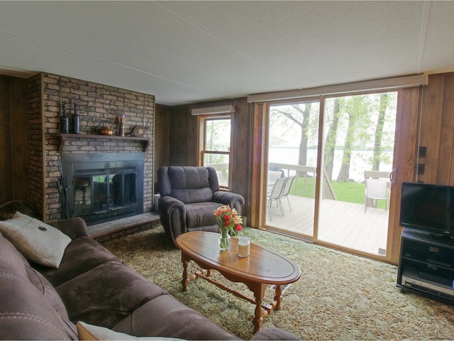 244 Tranquility Ln, Saint Albans Town, VT 05478 - carpeted living room with wood walls and a fireplace