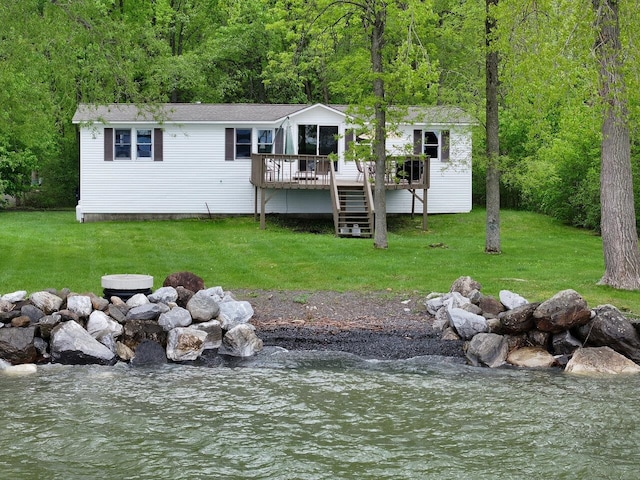 244 Tranquility Ln, Saint Albans Town, VT 05478 - rear view of house with a wooded view, a deck with water view, and a lawn