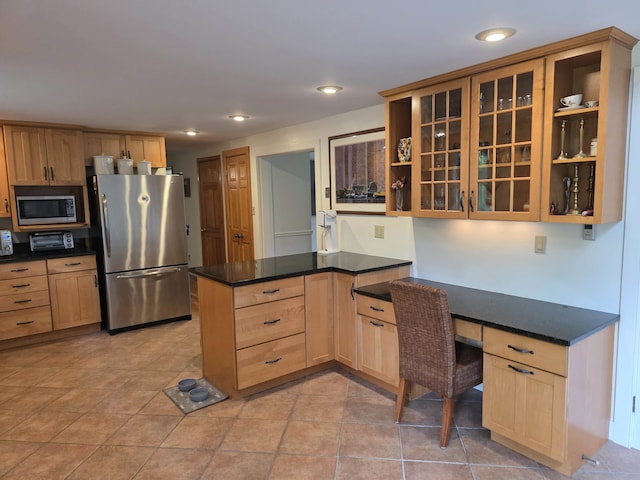 1073 Upper Dummerston Rd, Brattleboro, VT 05301 - kitchen featuring appliances with stainless steel finishes, a peninsula, open shelves, light brown cabinetry, and glass insert cabinets