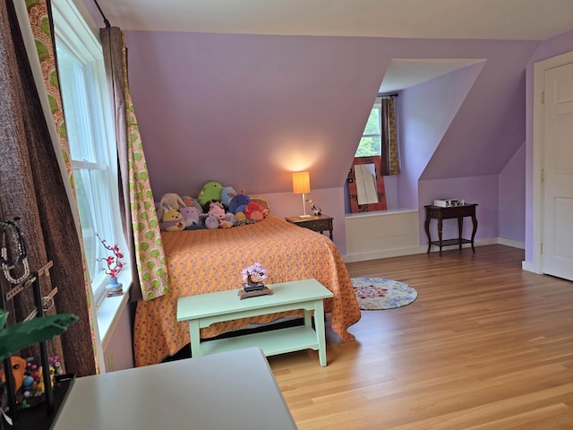 1073 Upper Dummerston Rd, Brattleboro, VT 05301 - bedroom featuring wood finished floors, baseboards, and vaulted ceiling