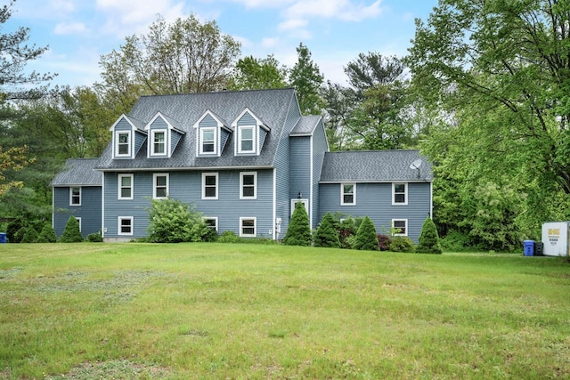 8 Quincy Rd Unit B, Londonderry, NH 03053 - view of front of house featuring a front yard, a shingled roof, and view of wooded area