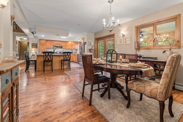 8 Mill Pond Rd, Grantham, NH 03753 - dining space featuring light wood-type flooring and a chandelier