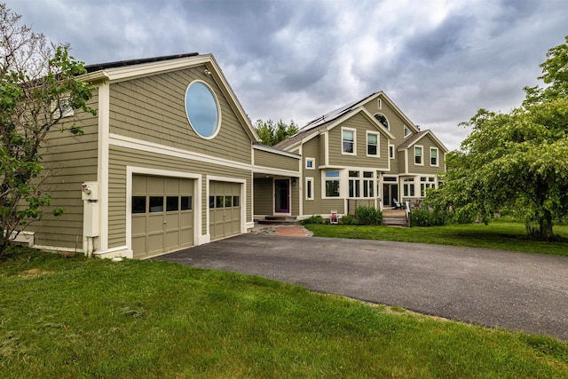 70 Fisk Rd, Concord, NH 03301 - view of front of house featuring asphalt driveway, a front lawn, and a garage