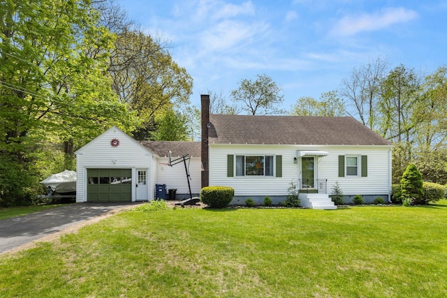 7 Lamson Ln, Hampton, NH 03842 - view of front of home featuring a chimney, asphalt driveway, a garage, a front yard, and a shingled roof