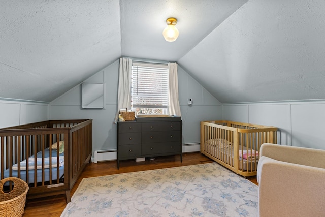 7 Lamson Ln, Hampton, NH 03842 - bedroom featuring a textured ceiling, wood finished floors, vaulted ceiling, a decorative wall, and a baseboard radiator