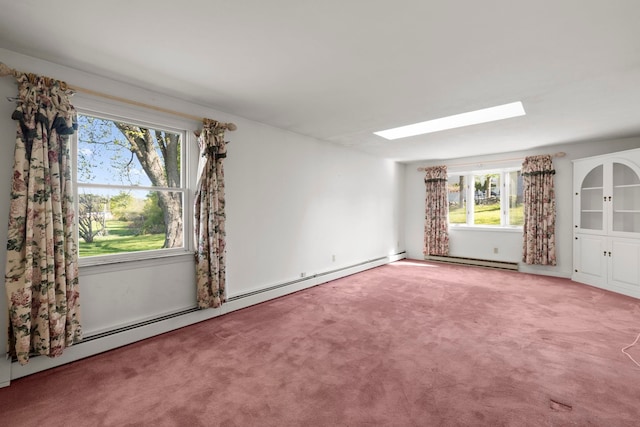 44 Weare Rd, Seabrook, NH 03874 - carpeted empty room featuring a skylight, baseboard heating, healthy amount of natural light, and a baseboard heating unit