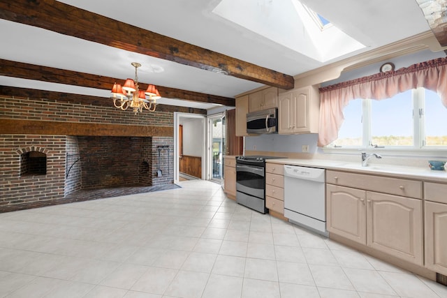 44 Weare Rd, Seabrook, NH 03874 - kitchen with stainless steel appliances, a chandelier, light countertops, brick wall, and a fireplace