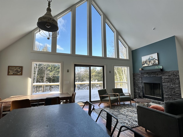 62 Highland Vws N, Ludlow, VT 05149 - dining space featuring high vaulted ceiling, a fireplace, and wood finished floors