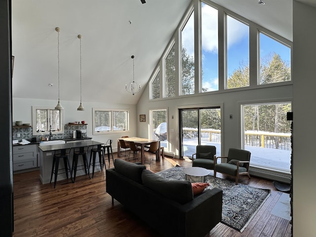 62 Highland Vws N, Ludlow, VT 05149 - living area featuring high vaulted ceiling, dark wood-style floors, and a chandelier