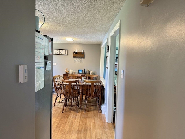 50 New Haven Rd, Vergennes, VT 05491 - dining area featuring light wood-style floors and a textured ceiling