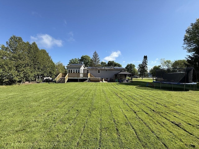 50 New Haven Rd, Vergennes, VT 05491 - view of green lawn featuring a trampoline, a gazebo, and a wooden deck