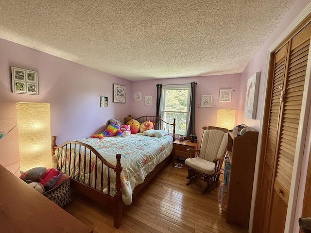 50 New Haven Rd, Vergennes, VT 05491 - bedroom with hardwood / wood-style flooring, a textured ceiling, and a closet