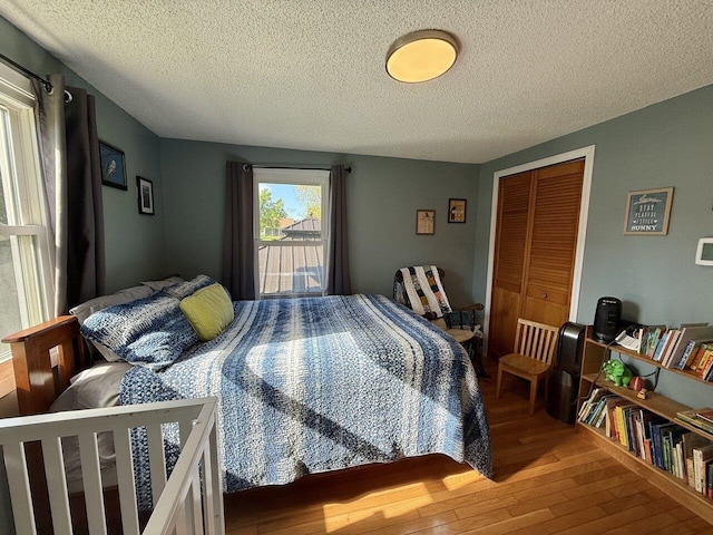 50 New Haven Rd, Vergennes, VT 05491 - bedroom with hardwood / wood-style floors, a textured ceiling, and a closet