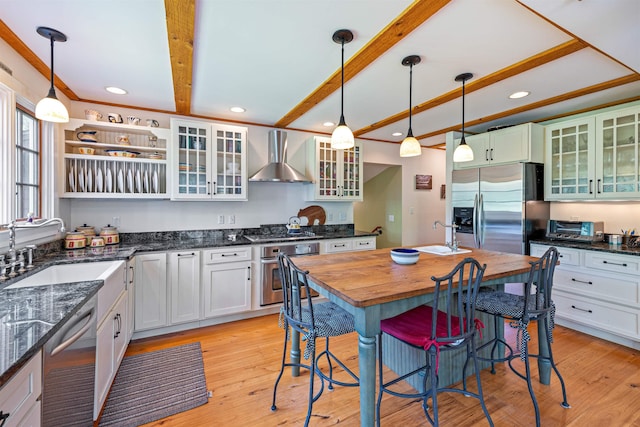 10 Wiswall Hill Rd, Newfane, VT 05345 - kitchen with appliances with stainless steel finishes, wall chimney range hood, beam ceiling, a kitchen breakfast bar, and a sink