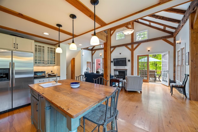10 Wiswall Hill Rd, Newfane, VT 05345 - kitchen featuring built in refrigerator, beam ceiling, butcher block countertops, hardwood / wood-style flooring, and a fireplace