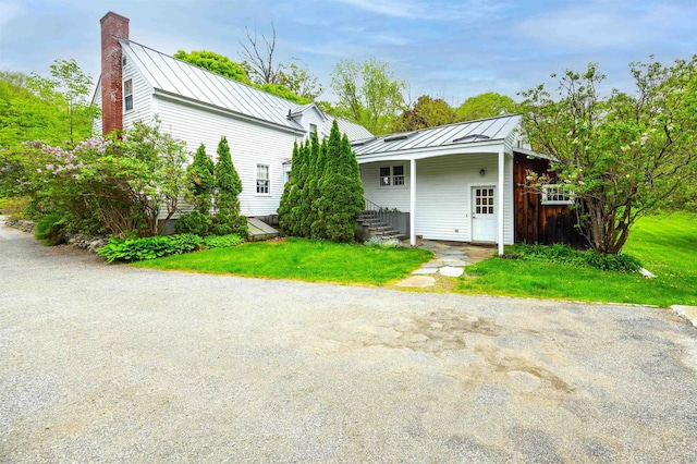10 Wiswall Hill Rd, Newfane, VT 05345 - back of house featuring a standing seam roof, a chimney, and metal roof
