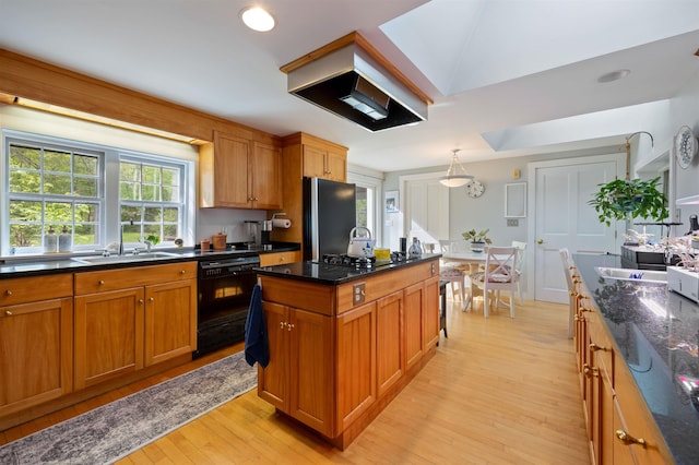 10 Wiswall Hill Rd, Newfane, VT 05345 - kitchen featuring black appliances, light wood finished floors, premium range hood, a sink, and brown cabinetry
