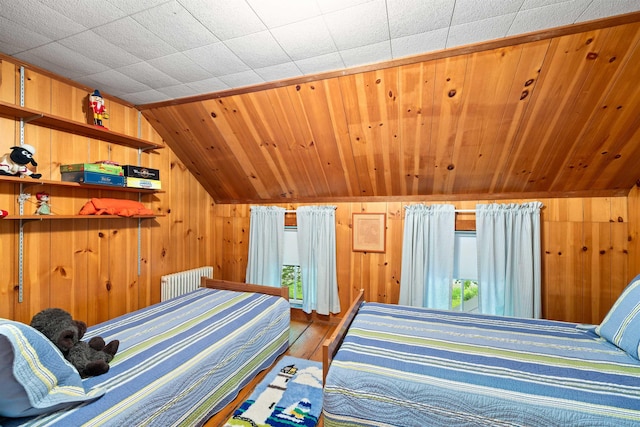 10 Wiswall Hill Rd, Newfane, VT 05345 - bedroom featuring wood finished floors, lofted ceiling, wooden walls, and radiator
