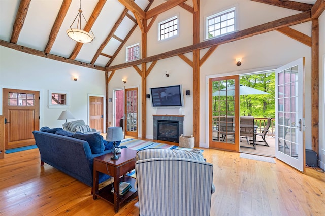 10 Wiswall Hill Rd, Newfane, VT 05345 - living room featuring high vaulted ceiling, light wood-style floors, beamed ceiling, and a glass covered fireplace