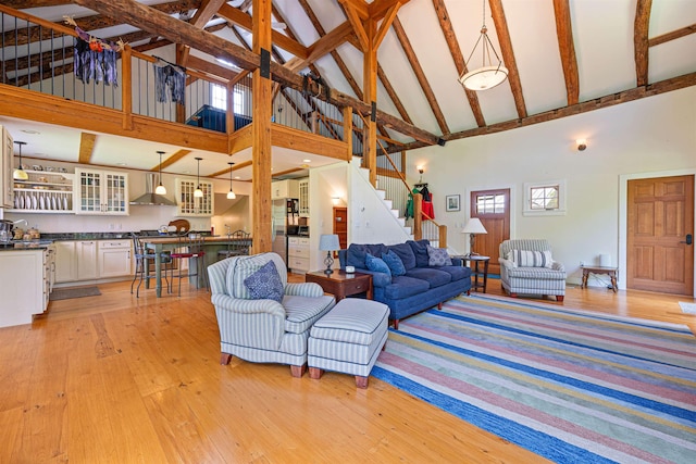 10 Wiswall Hill Rd, Newfane, VT 05345 - living area featuring high vaulted ceiling, stairway, light wood-style flooring, and beamed ceiling