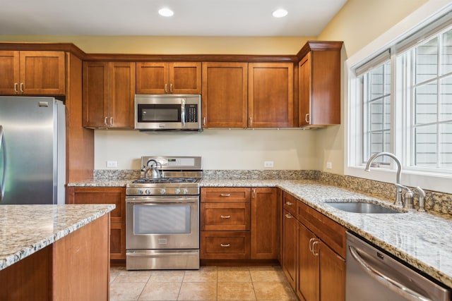 222 Park View Rd, Springfield, VT 05156 - kitchen featuring appliances with stainless steel finishes, a sink, light stone countertops, recessed lighting, and brown cabinetry
