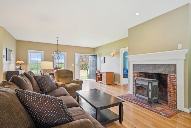 222 Park View Rd, Springfield, VT 05156 - living room featuring light wood-style flooring, a chandelier, a wood stove, recessed lighting, and baseboards