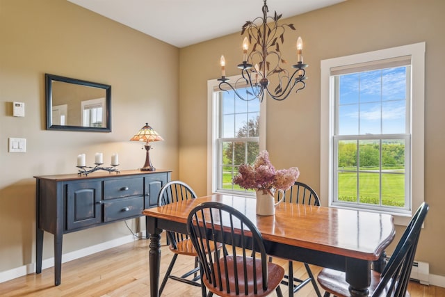 222 Park View Rd, Springfield, VT 05156 - dining area with a chandelier, light wood-style flooring, and baseboards