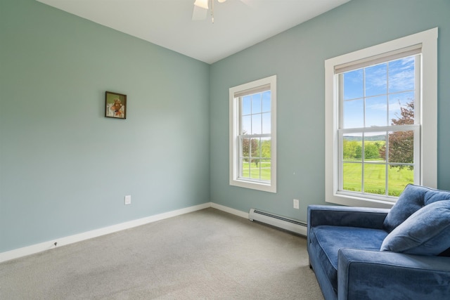 222 Park View Rd, Springfield, VT 05156 - living area with a baseboard heating unit, light colored carpet, ceiling fan, and baseboards