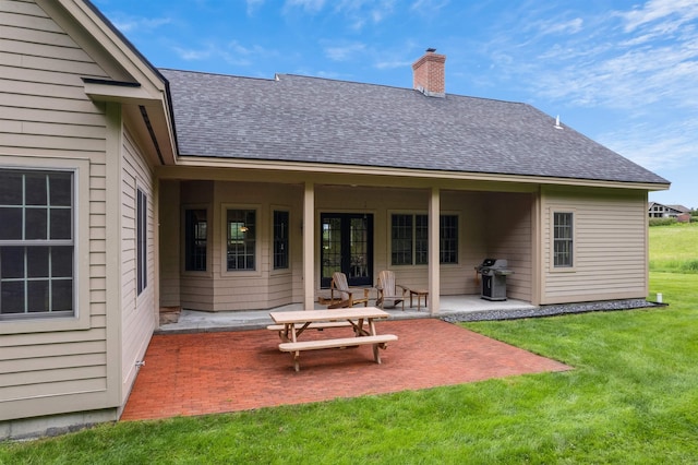 222 Park View Rd, Springfield, VT 05156 - back of house with a shingled roof, a patio area, a chimney, and a yard