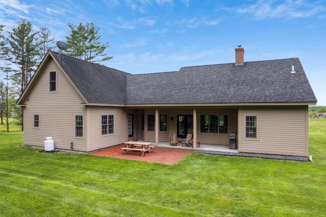 222 Park View Rd, Springfield, VT 05156 - back of property featuring roof with shingles, a chimney, a yard, and a patio