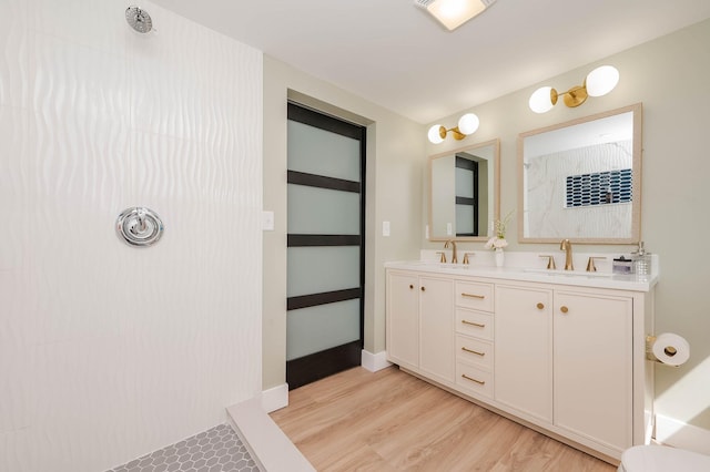 42 College Rd, Stratham, NH 03885 - bathroom featuring double vanity, wood finished floors, and a shower