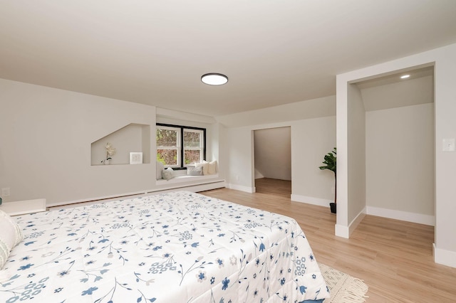 42 College Rd, Stratham, NH 03885 - bedroom with light wood-style floors, a baseboard radiator, and baseboards