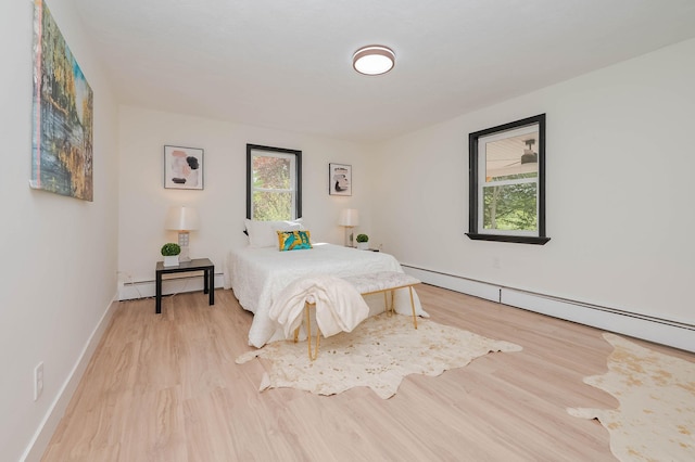 42 College Rd, Stratham, NH 03885 - bedroom with a baseboard heating unit, light wood-type flooring, baseboard heating, and baseboards