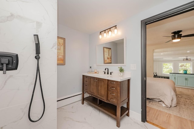 42 College Rd, Stratham, NH 03885 - ensuite bathroom with vanity, marble look tile flooring, a baseboard radiator, and baseboards