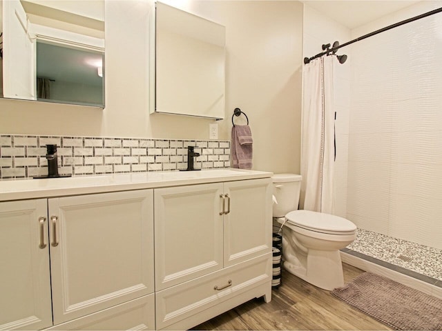 1585 Amidon Rd Unit 1, 2, 3, Montgomery, VT 05471 - bathroom featuring toilet, decorative backsplash, double vanity, and a tile shower